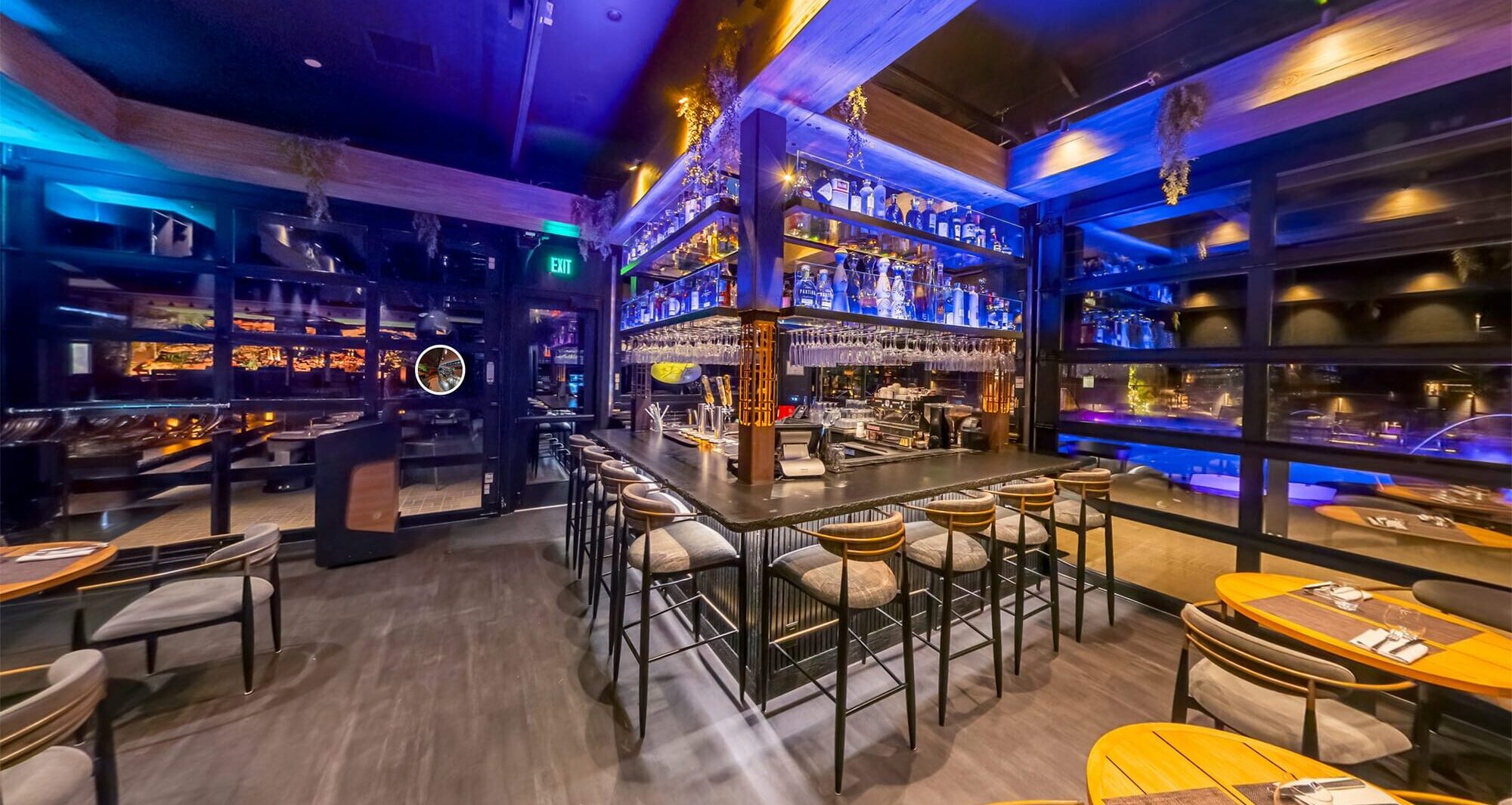 Modern bar interior at Restaurant Forty1 with illuminated shelves and barstools